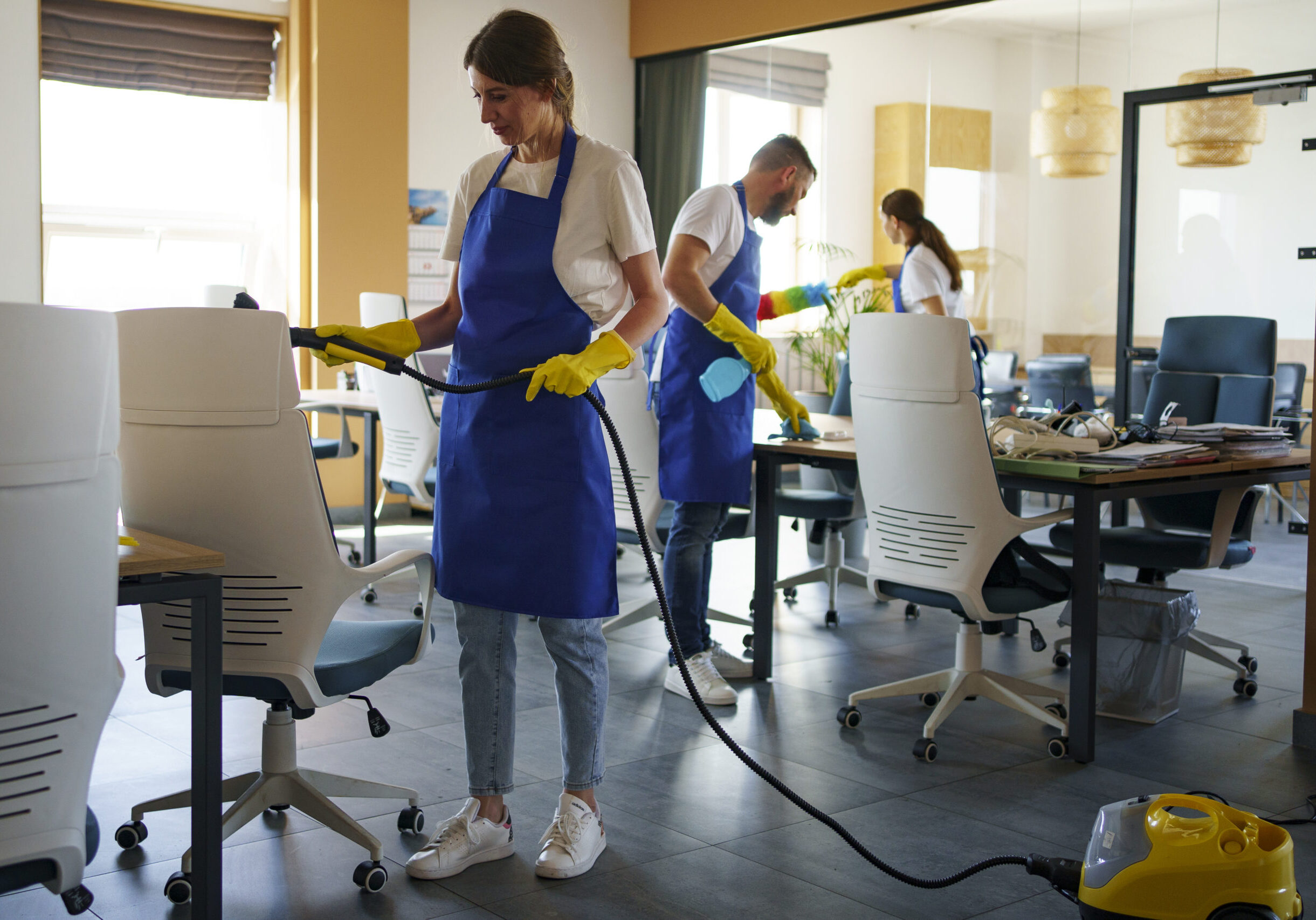 professional-cleaning-service-person-using-vacuum-cleaner-office